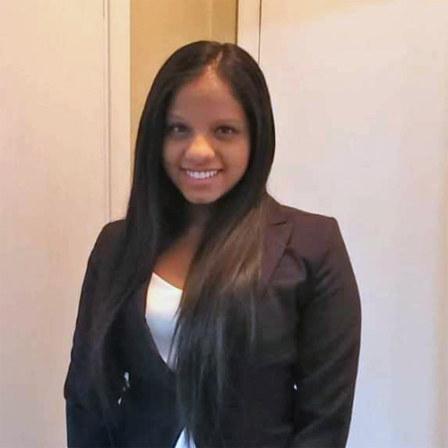 Karthyayani Ramesh wearing a blazer looking at camera