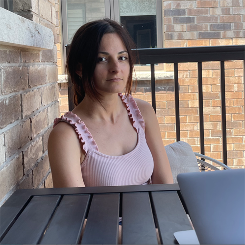 Milica Hinic sitting slightly turned to the right behind a table